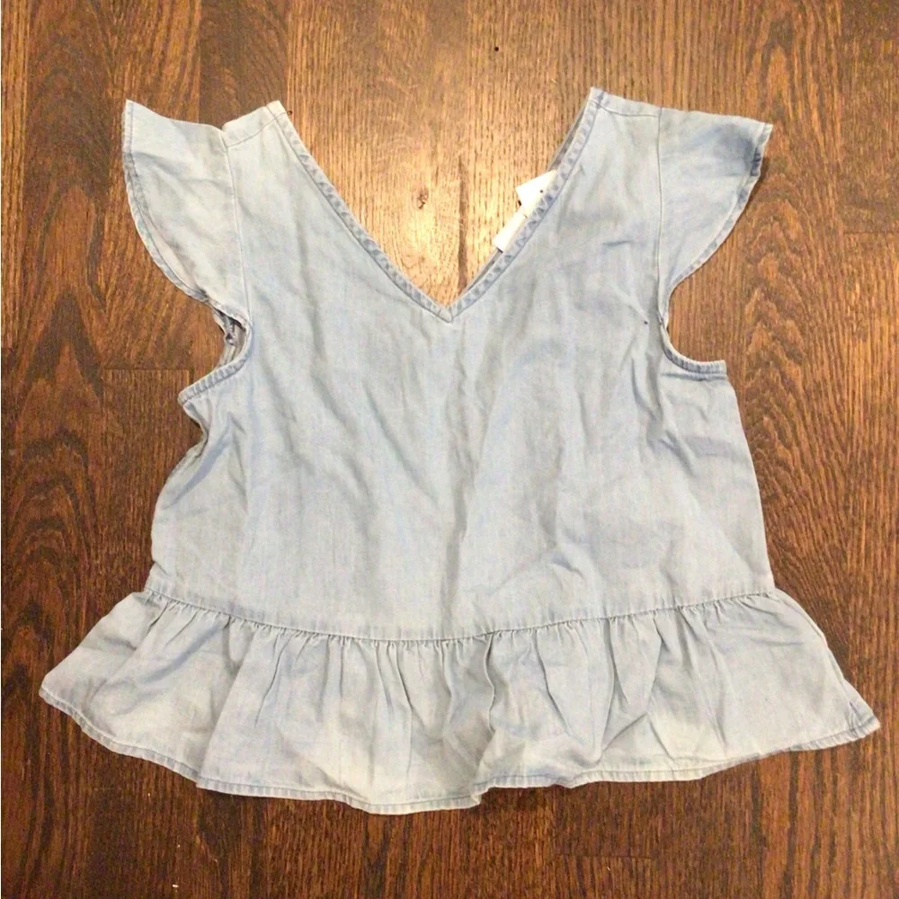 Gap - children's top is made of light-wash blue denim cotton.
